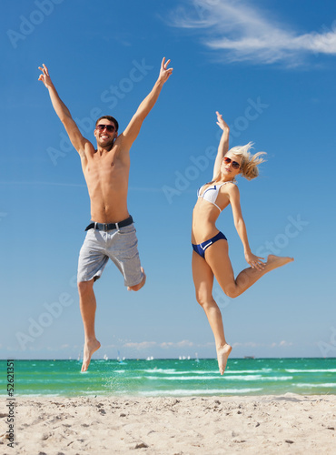 couple jumping on the beach