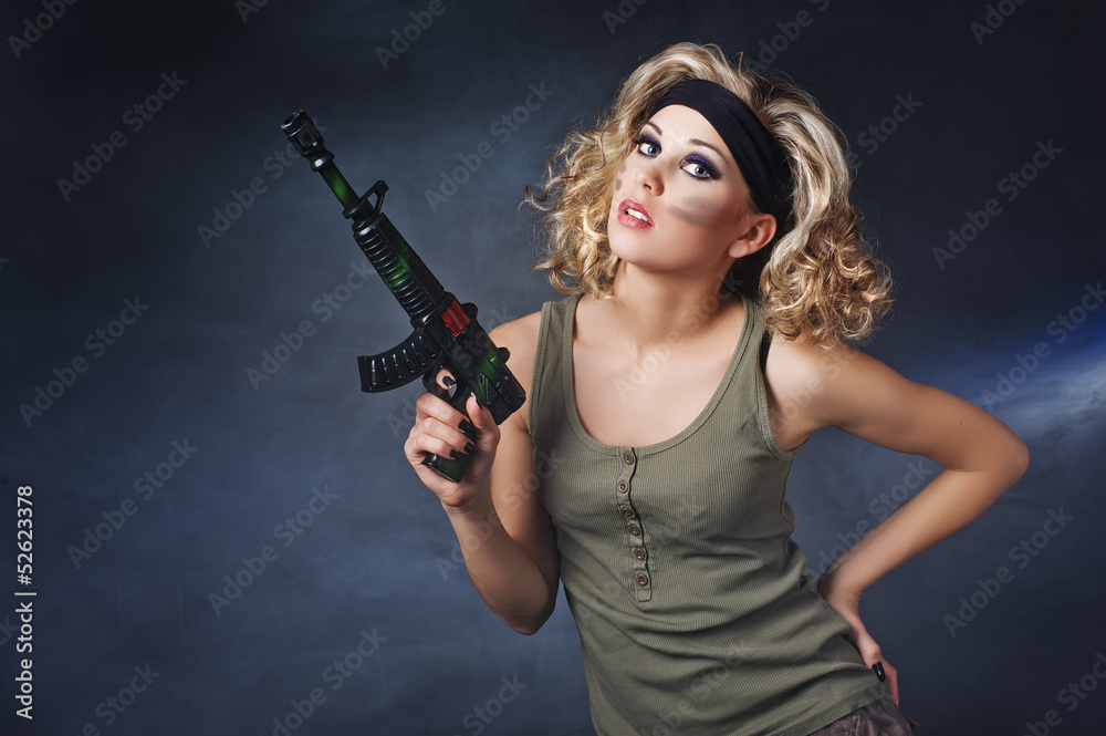 Military girl wearing a sexy outfit with a gun in his hand