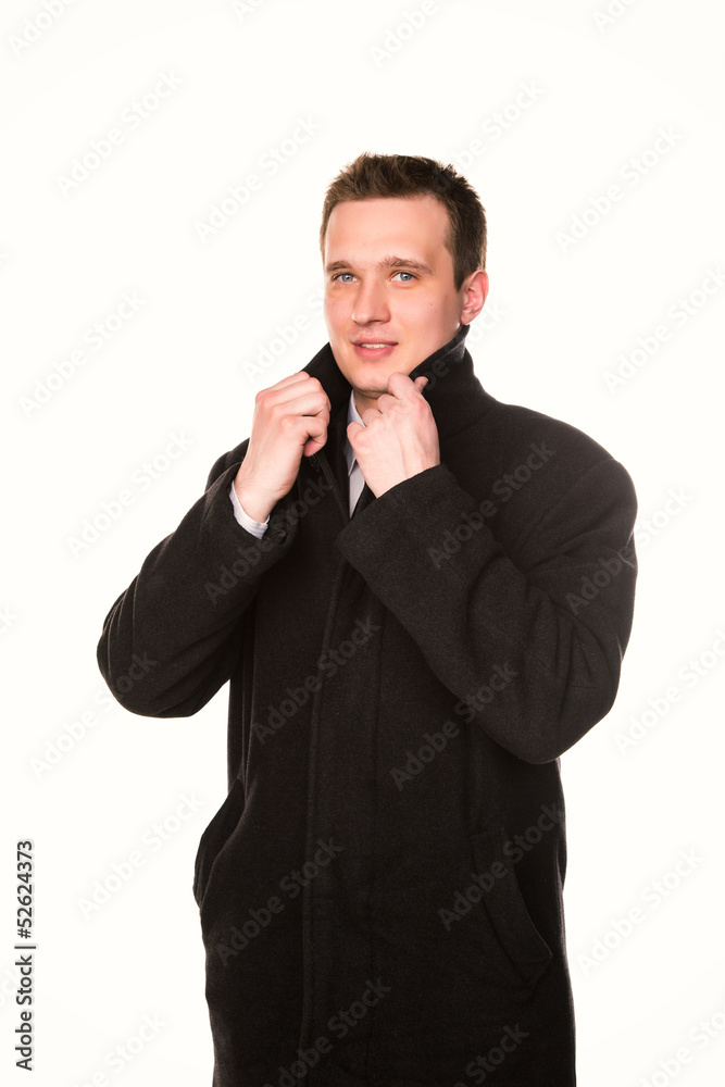Handsome young businessman in a coat isolated Handsome young businessman in a coat isolated