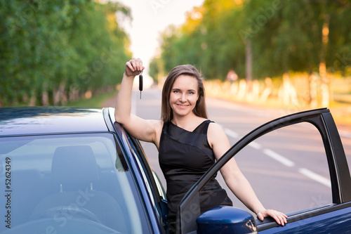 Beautiful businesswoman near her car