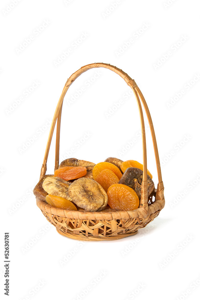 Dried apricots and figs in a wicker basket isolated on white Dried apricots and figs in a wicker basket isolated on white