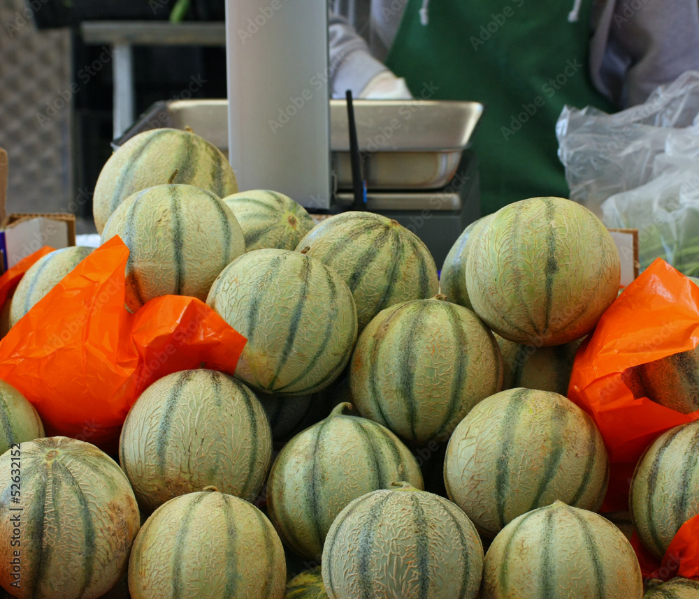 mature melons just picked up for sale by grocery store