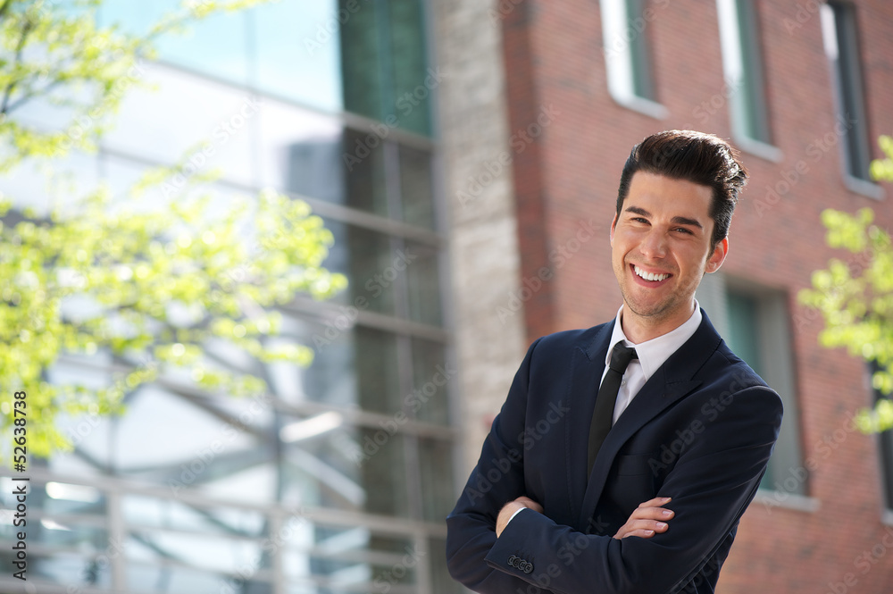 Handsome young businessman smiling outdoors Handsome young businessman smiling outdoors