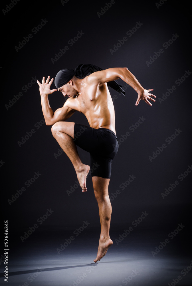 Dancer dancing in the dark studio