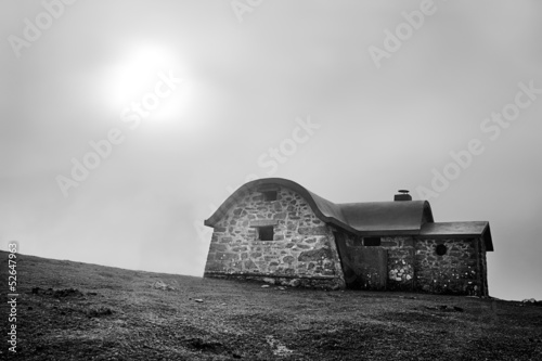 Shelter in mountain in the morning with fog and sun