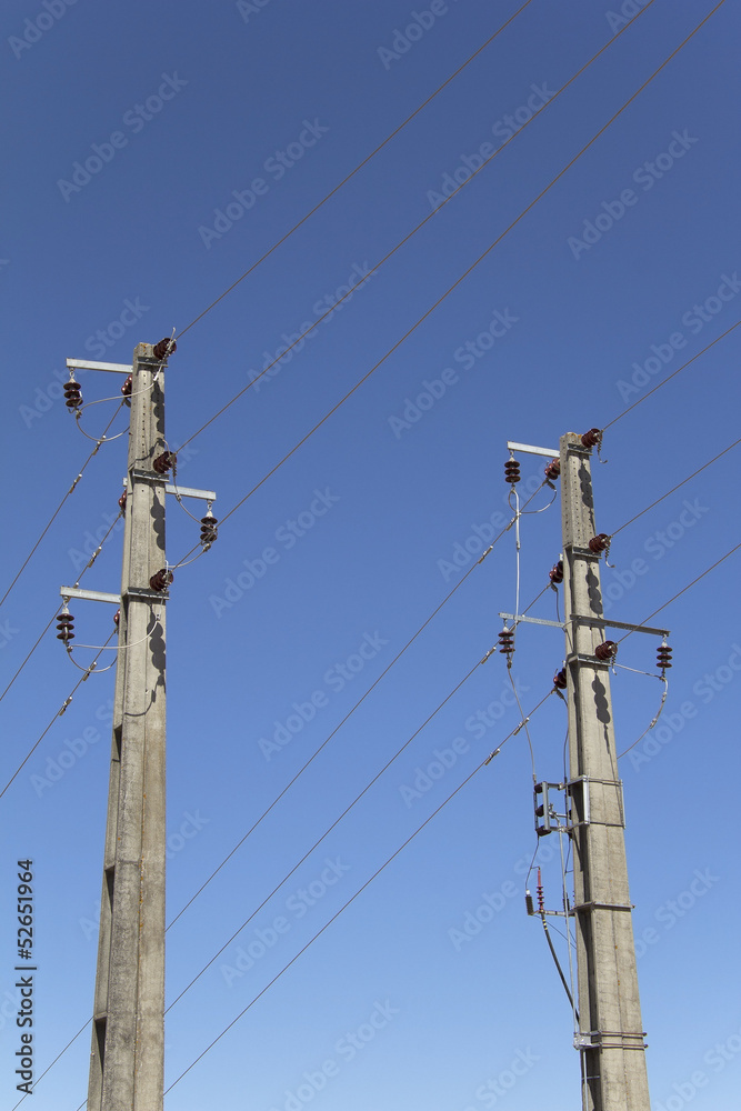 Electricity concrete pylons against clear blue sky Electricity concrete pylons against clear blue sky