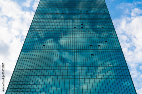 Modern blue glass wall of skyscraper in Warsaw