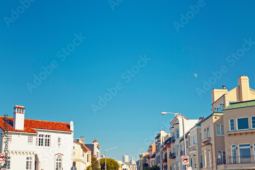 Street with houses of San Francisco with blue sky.