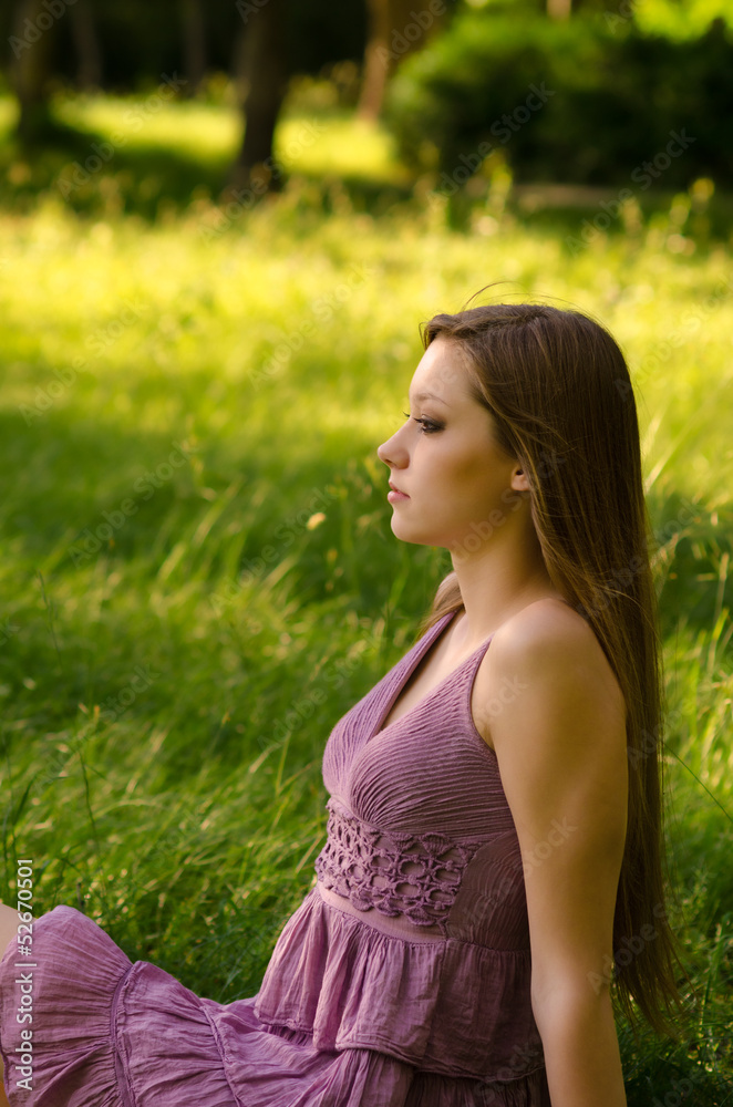 Beautiful woman sittign on the meadow Beautiful woman sittign on the meadow