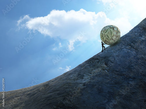 Photos Tiny man pushing a ball of money up hill