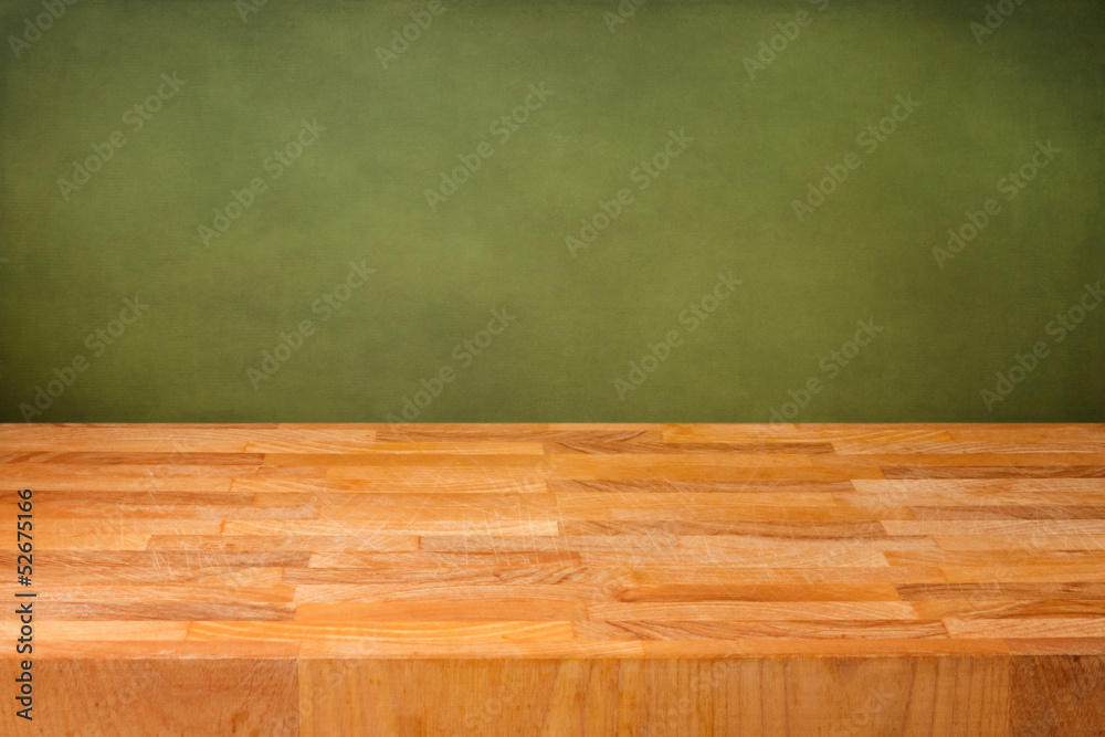 Empty wooden deck table over grunge green background Empty wooden deck table over grunge green background