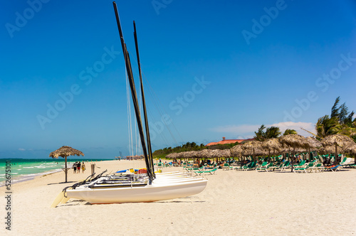 Photography Varadero beach in Cuba with boats and tourists sunbathing