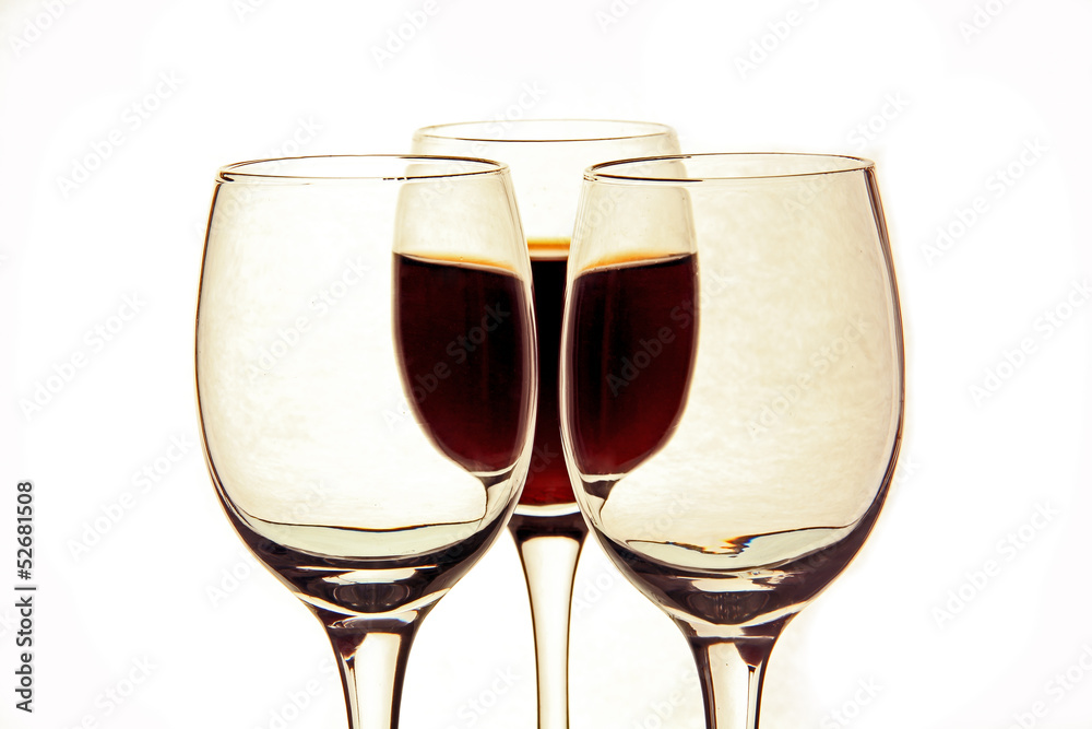a glass of wine and empty glasses.