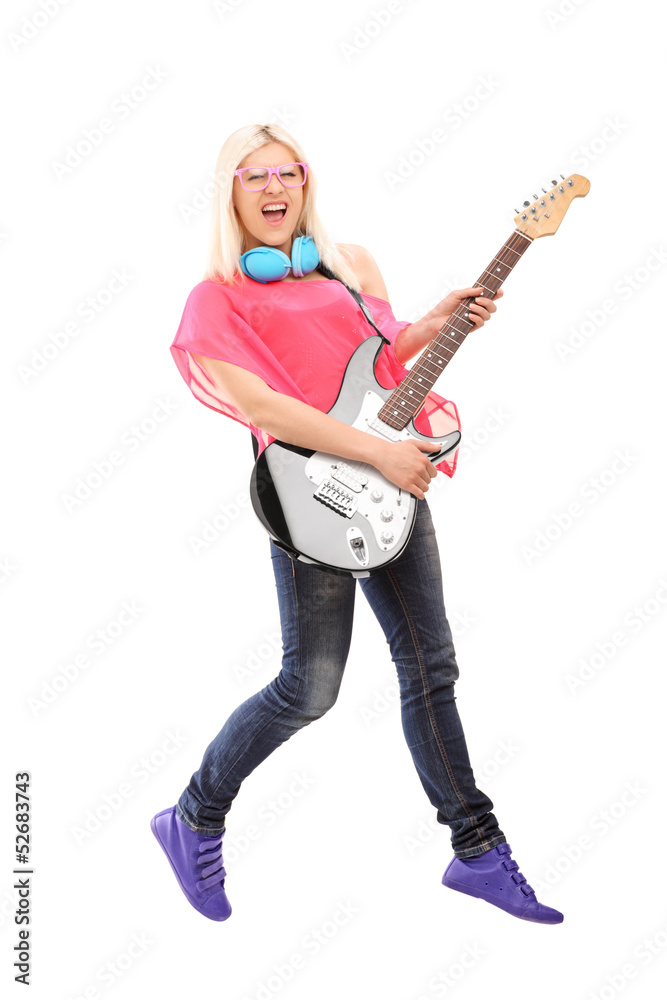 Full length portrait of a female rock star jumping and playing Full length portrait of a female rock star jumping and playing