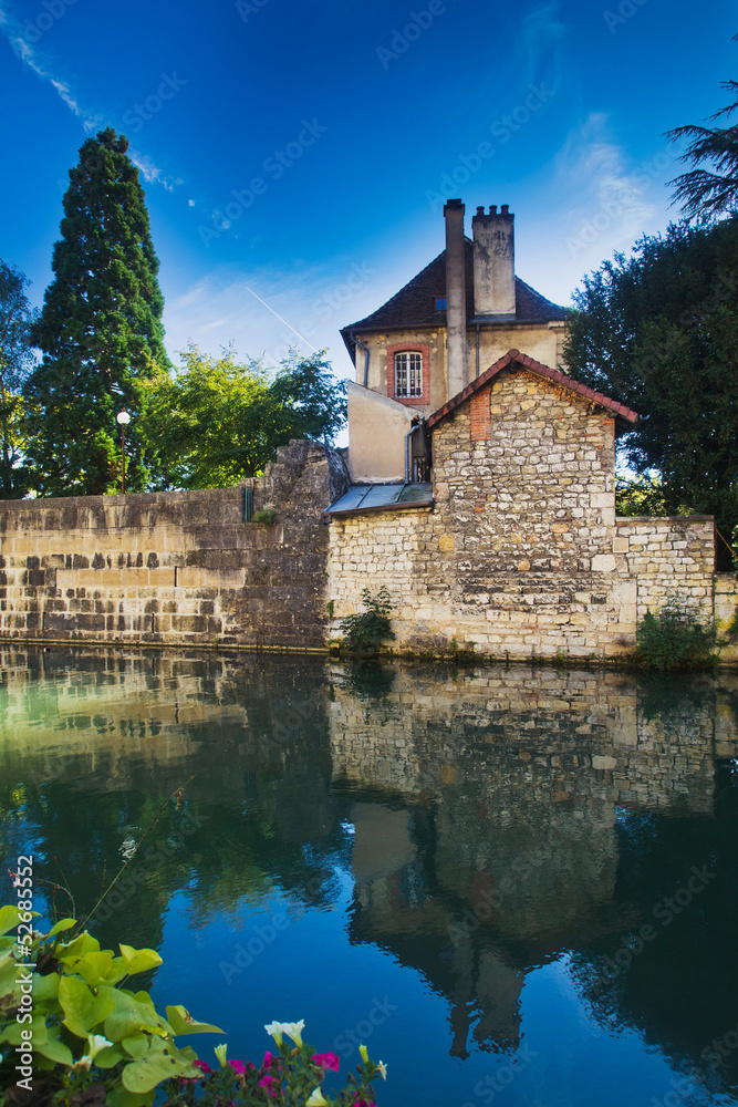 landscape with the reflection of an old house in the river