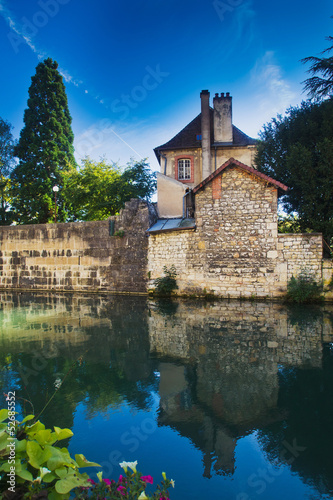 landscape with the reflection of an old house in the river
