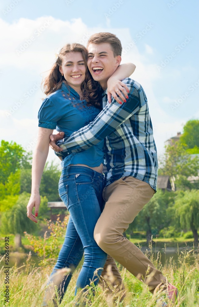 Happy teenage couple boy and girl embracing Happy teenage couple boy and girl embracing