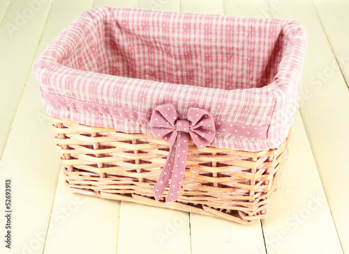 Wicket basket with pink fabric and bow,