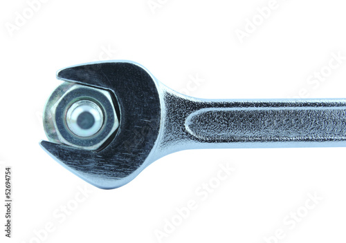 Detail of chrome wrench turning a nut on a bolt