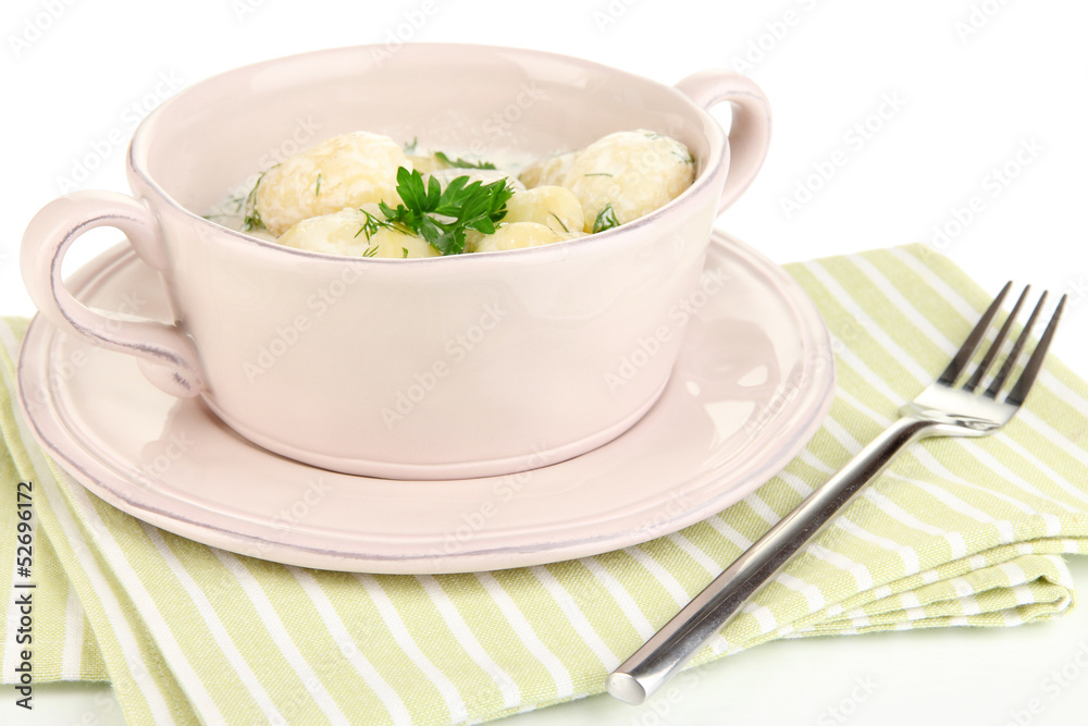 Tender young potatoes with sour cream and herbs in pan isolated Tender young potatoes with sour cream and herbs in pan isolated