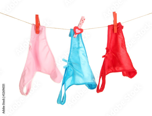 Women's panties hanging on rope isolated on white