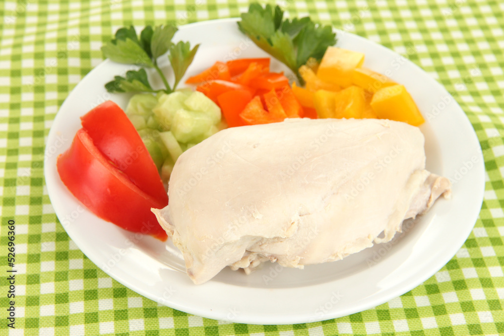 Boiled chicken breast on plate with vegetables close up Boiled chicken breast on plate with vegetables close up
