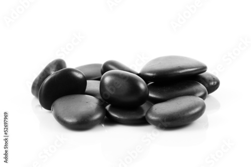 Black massage stones stacked  isolated.