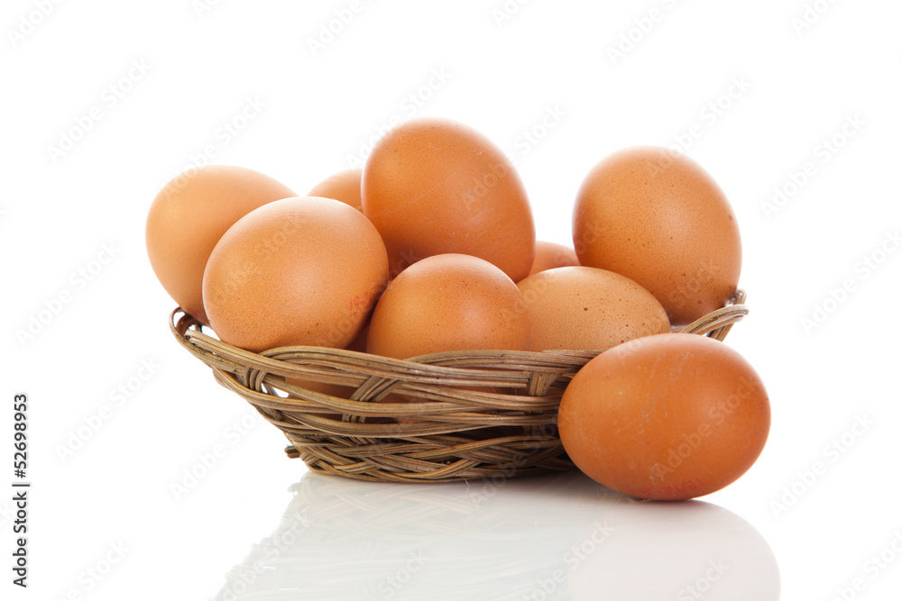 Brown eggs in the basket on white. Brown eggs in the basket on white.