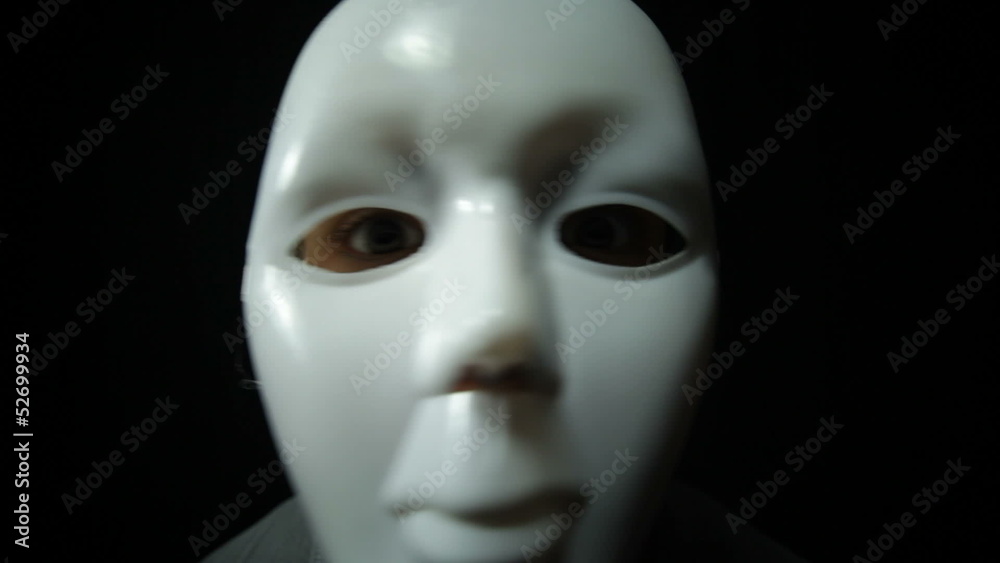 Scary masked man over dark background Scary masked man over dark background