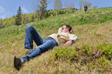 Man lying on a steep hillside