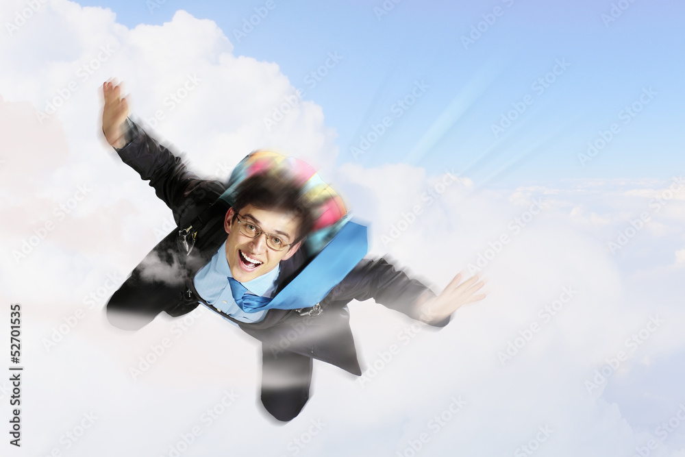 Young businessman flying with parachute on back Young businessman flying with parachute on back