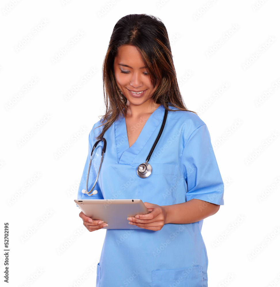 Smiling asiatic nurse woman working on tablet pc Smiling asiatic nurse woman working on tablet pc