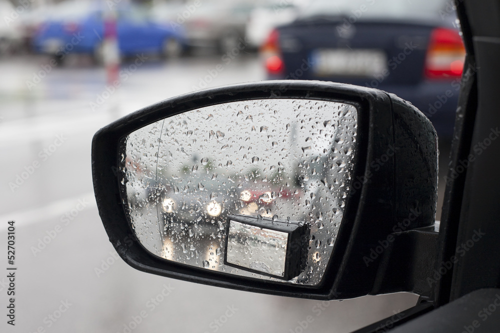 Wet by the rain the car mirror, blurry cars in mirror. Wet by the rain the car mirror, blurry cars in mirror.