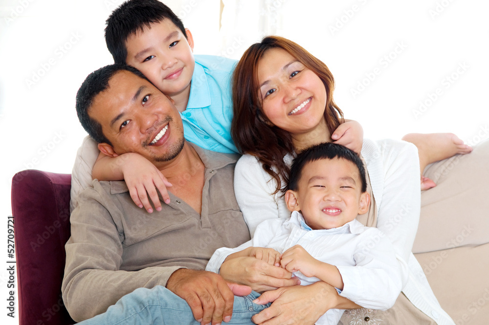 Portrait of asian family sitting on sofa