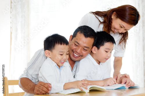 Asian family reading at home