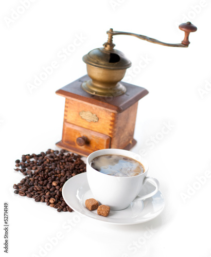 Cup of coffee with sugar and grinder