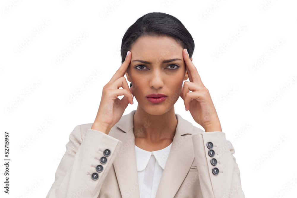 Businesswoman putting her fingers on her temples Businesswoman putting her fingers on her temples