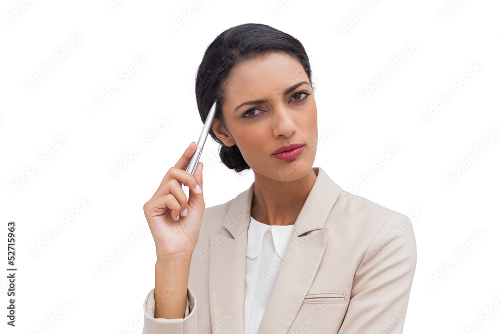 Thoughtful businesswoman holding a pen Thoughtful businesswoman holding a pen