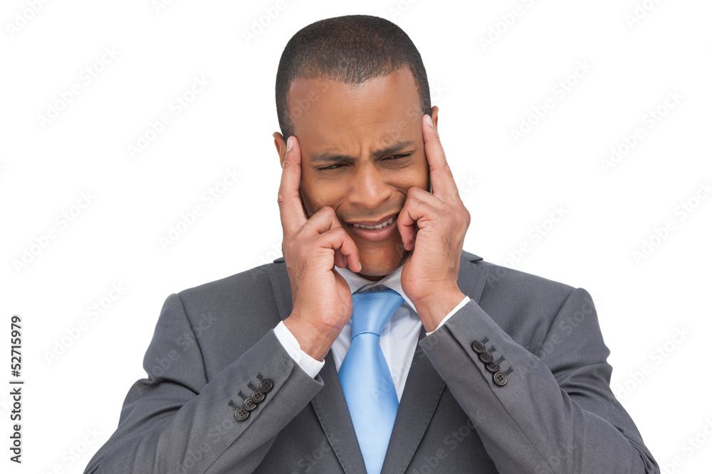 Stressed businessman putting his fingers on his temples Stressed businessman putting his fingers on his temples