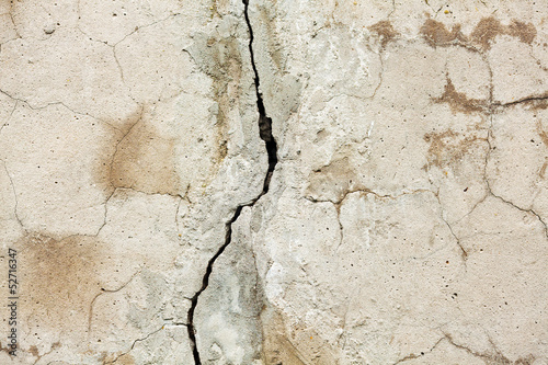 Broken concrete wall with cracks