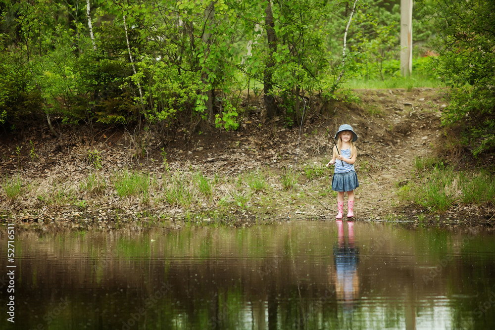 Little girl are fishing on lake in forest Little girl are fishing on lake in forest