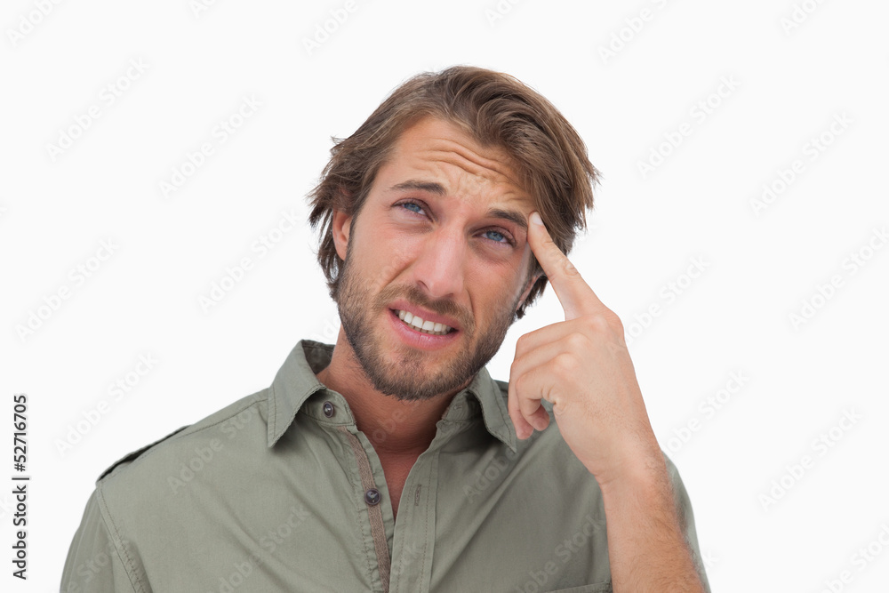 Man with headache looking up and touching his head Man with headache looking up and touching his head
