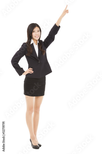 happy businesswoman pointing to copy space