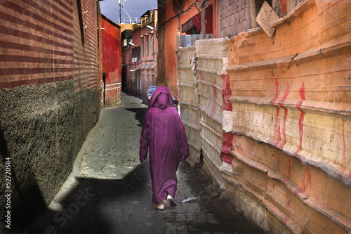 Woman in traditional crimson dress in Marrakesh street