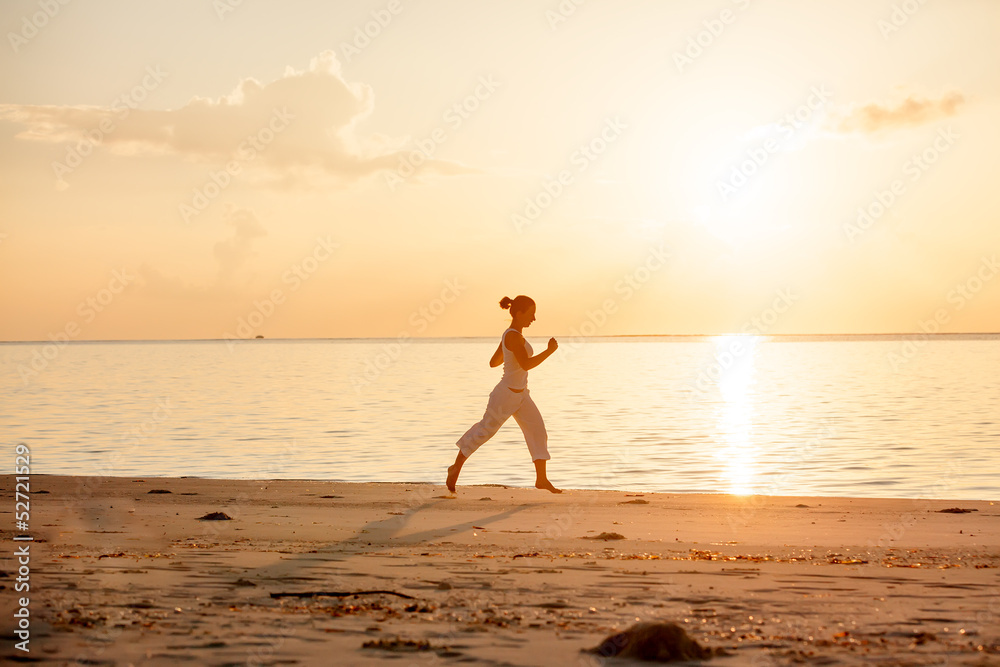 Caucasian woman jogging at seashore