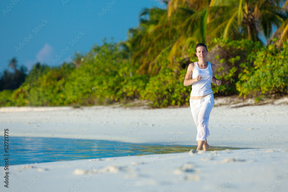 Caucasian woman jogging at seashore