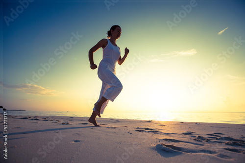Caucasian woman jogging at seashore © Maygutyak