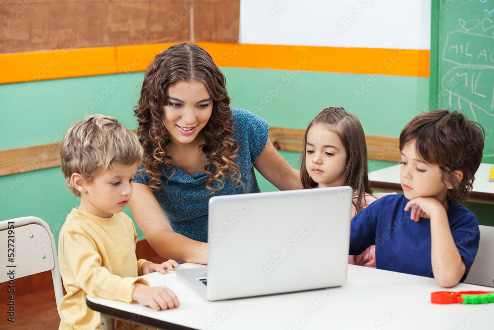 Teacher And Students Using Laptop In Class Teacher And Students Using Laptop In Class