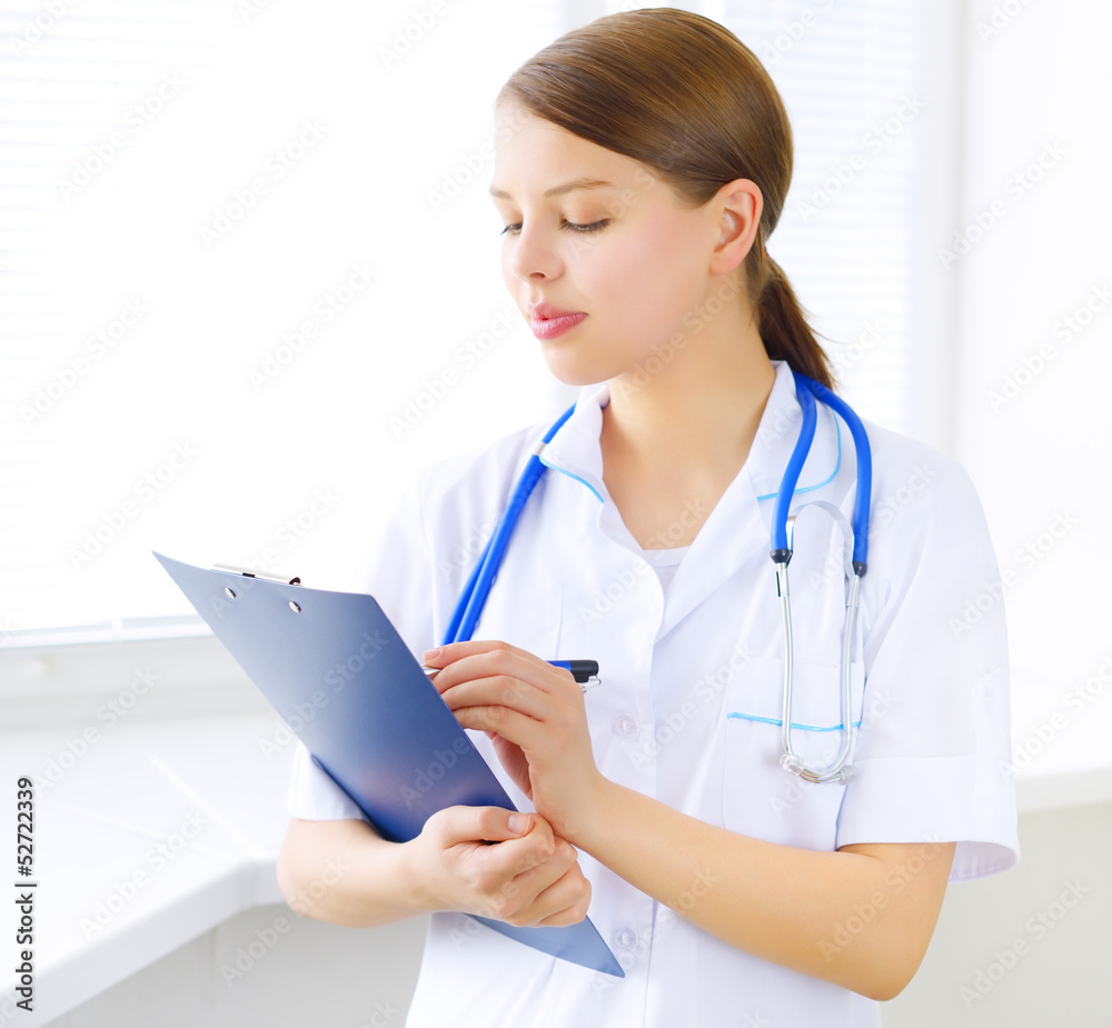 Female doctor with notepad Female doctor with notepad
