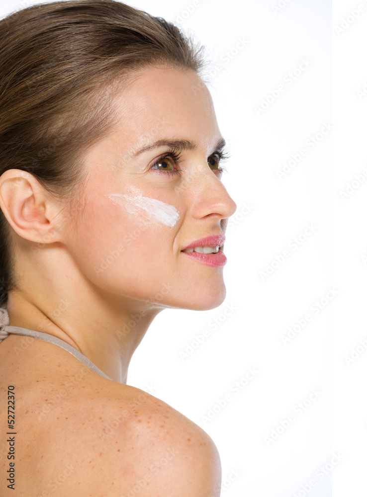 Obraz premium Beauty portrait of young woman with creme on cheek